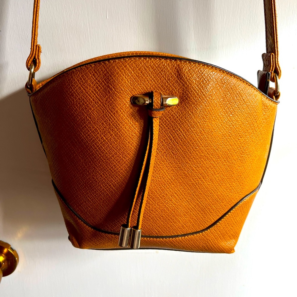 EUC Beautiful saddle leather colored Crossbody bag with brass, trim and tassels